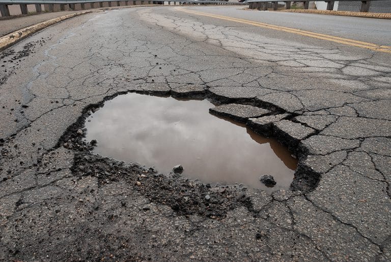 Pothole In Road With Broken Asphalt After Spring Thaw Viva MÉdia